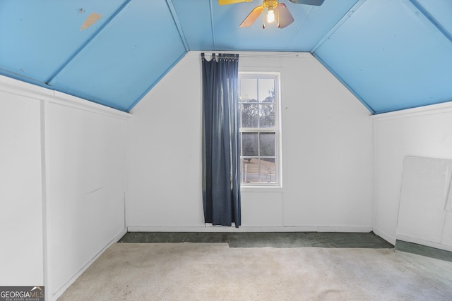 additional living space with vaulted ceiling, light colored carpet, and ceiling fan