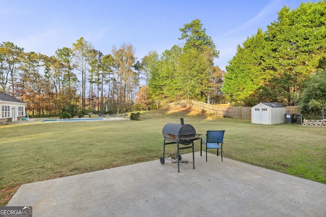 view of patio / terrace with a storage unit, a fenced in pool, and a grill