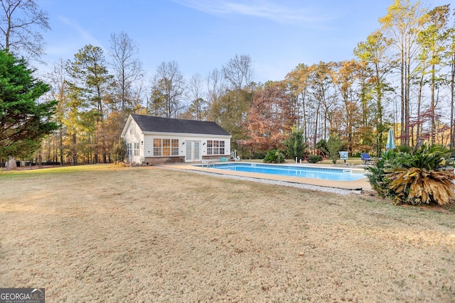 view of pool featuring a yard and an outdoor structure