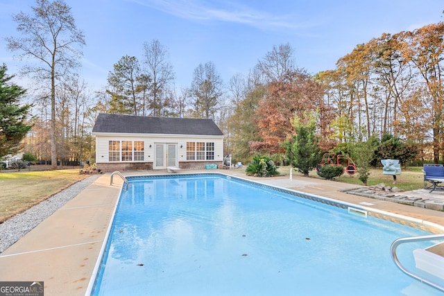 view of pool featuring an outdoor structure and a patio