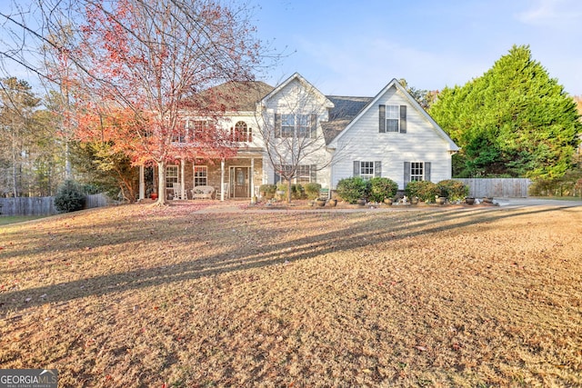 view of front facade featuring covered porch and a front yard