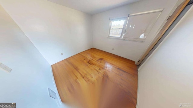 empty room with wood-type flooring