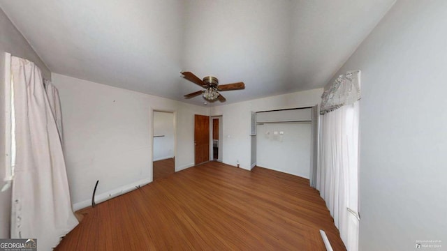 unfurnished bedroom featuring hardwood / wood-style floors and ceiling fan