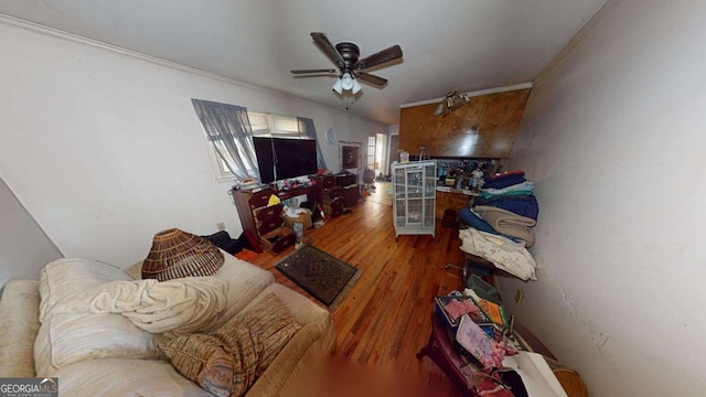 living room featuring hardwood / wood-style flooring, ceiling fan, and ornamental molding