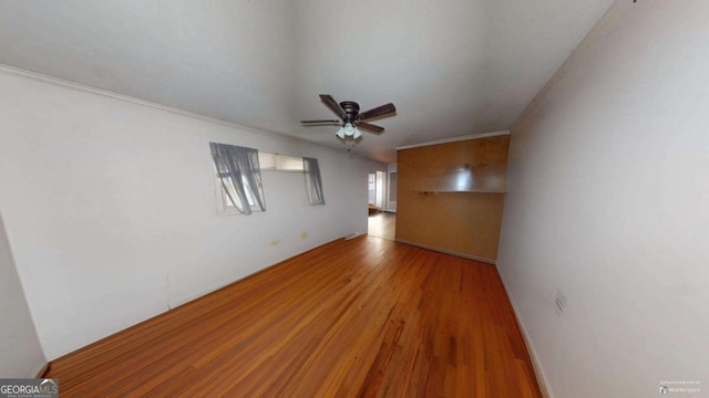 unfurnished living room with ceiling fan, wood-type flooring, and crown molding