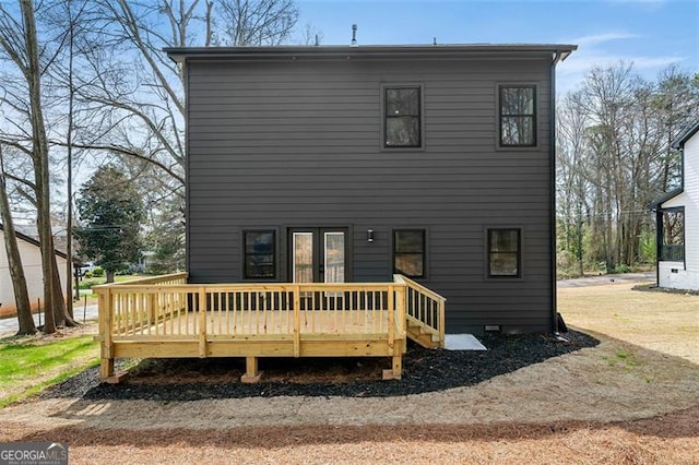 back of house with a wooden deck