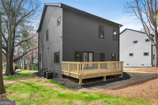 rear view of property featuring a deck and central air condition unit