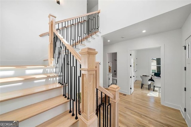 staircase with wood-type flooring