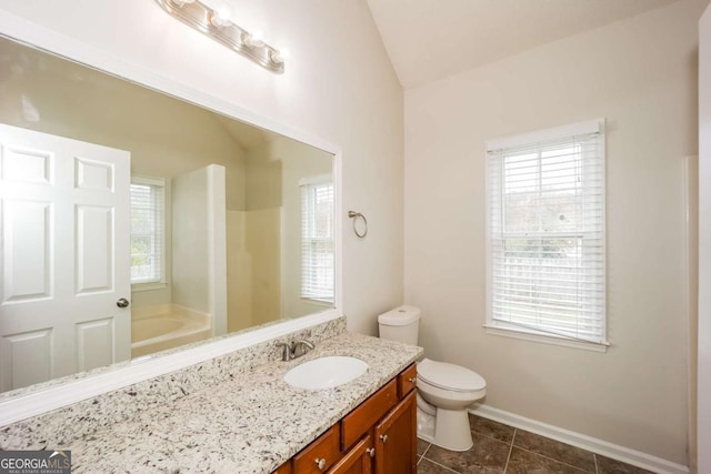 bathroom featuring tile patterned floors, a washtub, vanity, toilet, and lofted ceiling