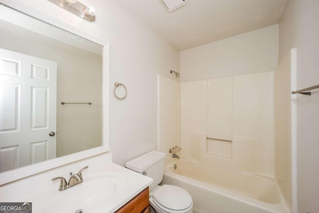 full bathroom featuring vanity, toilet, shower / bath combination, and a textured ceiling