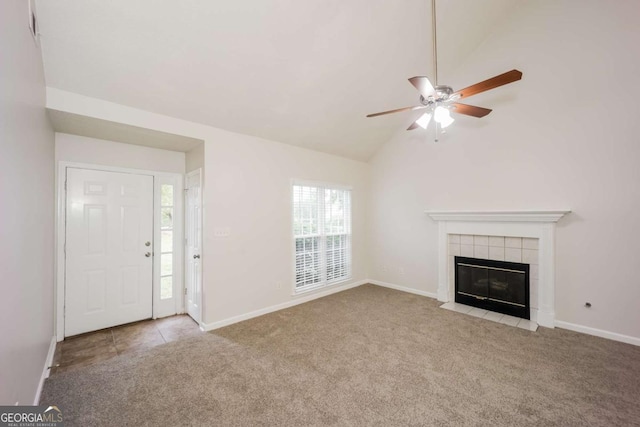 unfurnished living room featuring light carpet, a tile fireplace, lofted ceiling, and ceiling fan