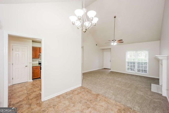 unfurnished living room with ceiling fan with notable chandelier, light colored carpet, and high vaulted ceiling