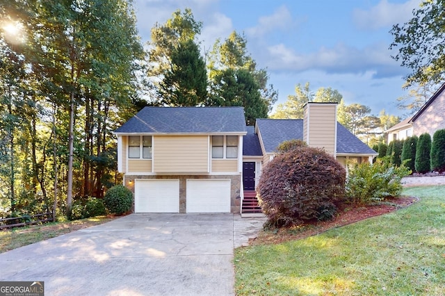 view of front of property with a garage and a front lawn