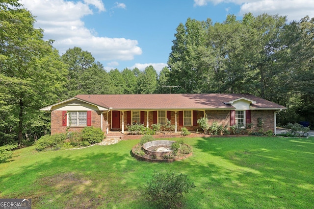 ranch-style house featuring a porch and a front yard