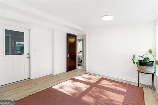 entryway with hardwood / wood-style floors