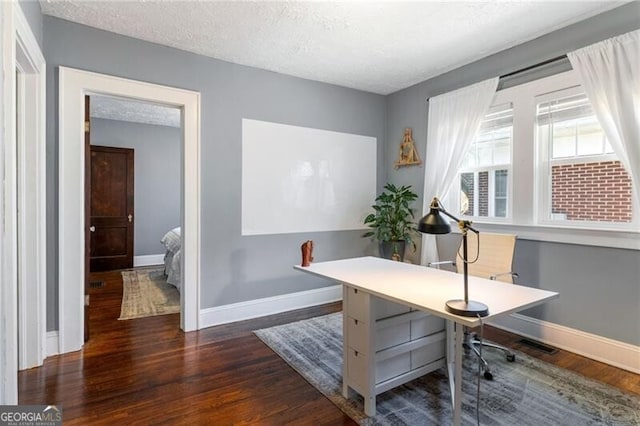 office space featuring dark hardwood / wood-style floors and a textured ceiling