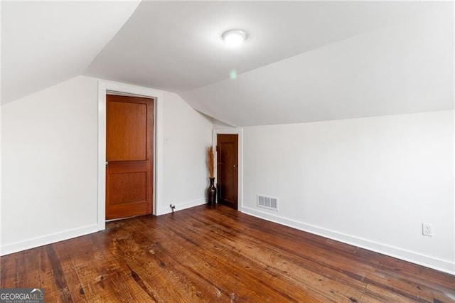 additional living space with lofted ceiling and dark hardwood / wood-style floors