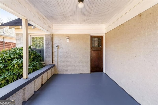 unfurnished sunroom with wooden ceiling