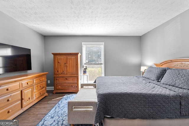 bedroom featuring dark hardwood / wood-style flooring and a textured ceiling