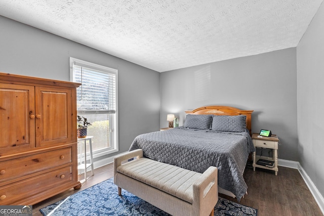 bedroom featuring dark hardwood / wood-style floors and a textured ceiling