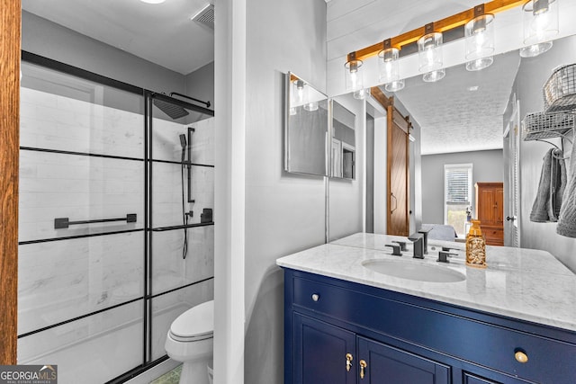 bathroom featuring a textured ceiling, vanity, toilet, and walk in shower