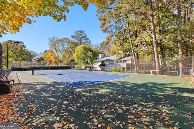 view of tennis court with basketball hoop