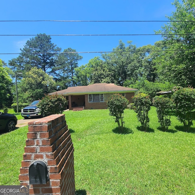 2045 Howe Ave, Columbus, GA 31903 - view of front of property featuring a front yard, driveway, and brick siding