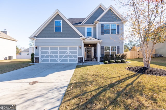 craftsman-style house featuring central AC, a front yard, and a garage