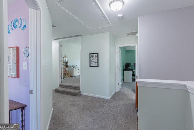 corridor featuring light colored carpet