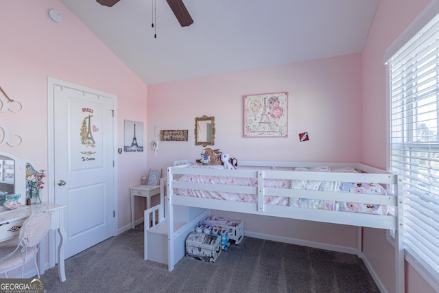 bedroom with ceiling fan, dark carpet, and lofted ceiling