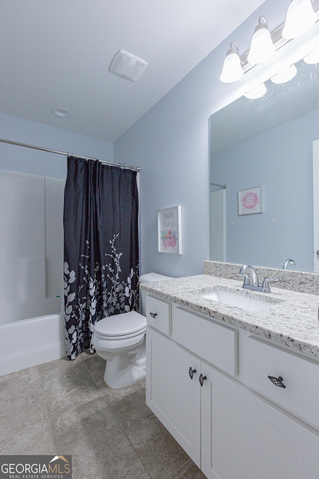 full bathroom featuring tile patterned floors, vanity, toilet, and shower / bath combo with shower curtain