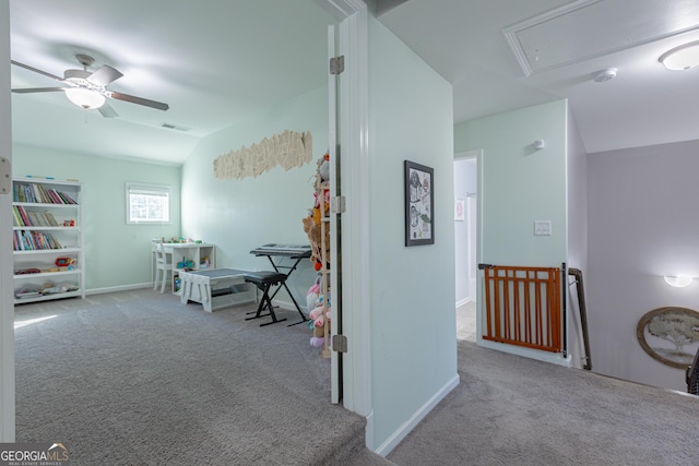 corridor with light colored carpet and lofted ceiling