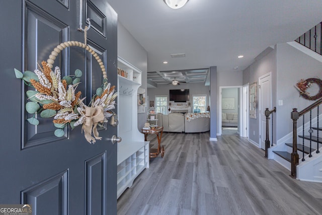 foyer entrance with beam ceiling, light hardwood / wood-style floors, and ceiling fan