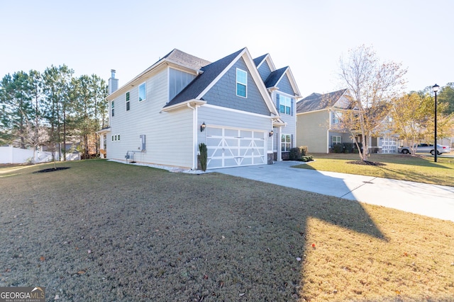 view of front property featuring a garage and a front lawn