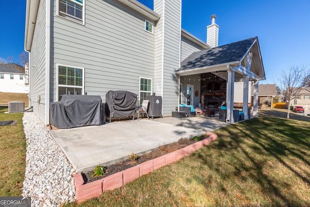 back of house with a patio area, a yard, and central AC