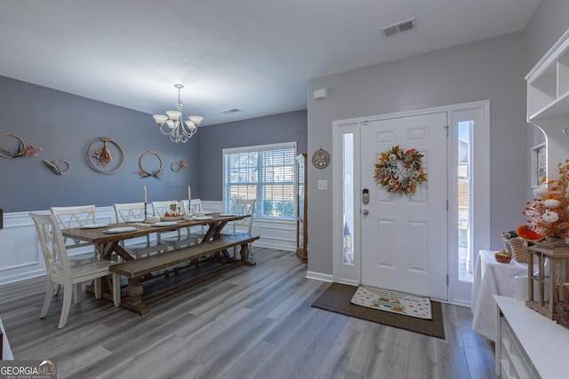 entrance foyer featuring light hardwood / wood-style floors and a chandelier