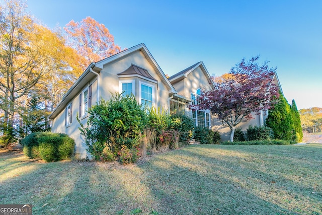 view of side of property with a yard