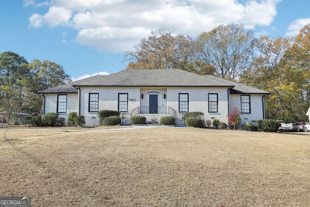 ranch-style home featuring a front yard