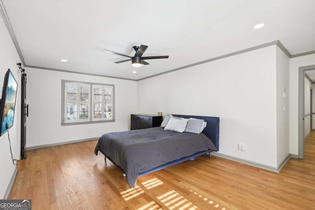 bedroom with crown molding, ceiling fan, and wood-type flooring