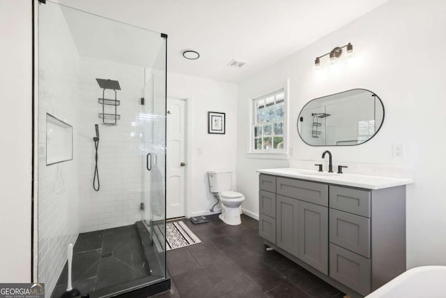 bathroom with vanity, an enclosed shower, and toilet