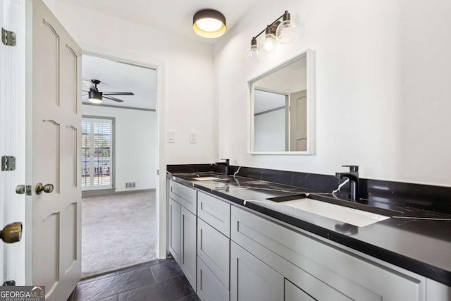 bathroom featuring ceiling fan and vanity