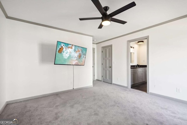 unfurnished bedroom with ceiling fan, ornamental molding, connected bathroom, and carpet floors