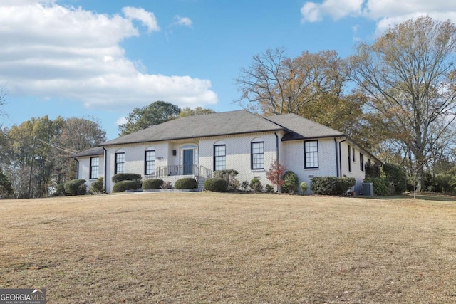 single story home featuring central AC unit and a front yard