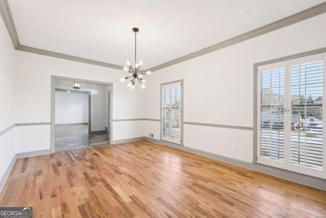 unfurnished dining area with hardwood / wood-style floors, a notable chandelier, and ornamental molding