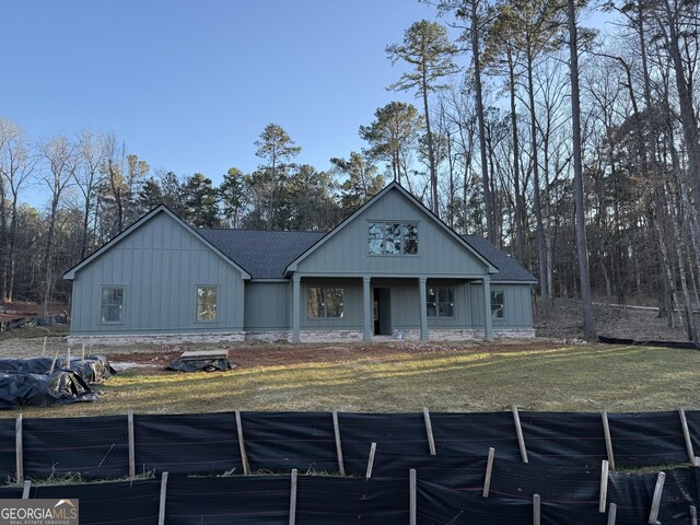 rear view of property featuring a yard