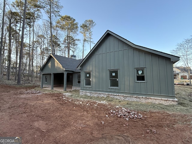 rustic home with a shingled roof and board and batten siding