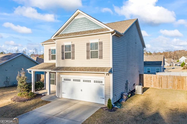 view of front of house with a garage and central AC