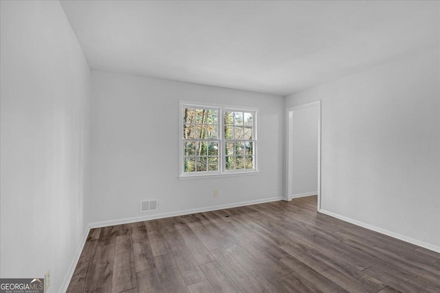 empty room featuring dark hardwood / wood-style floors