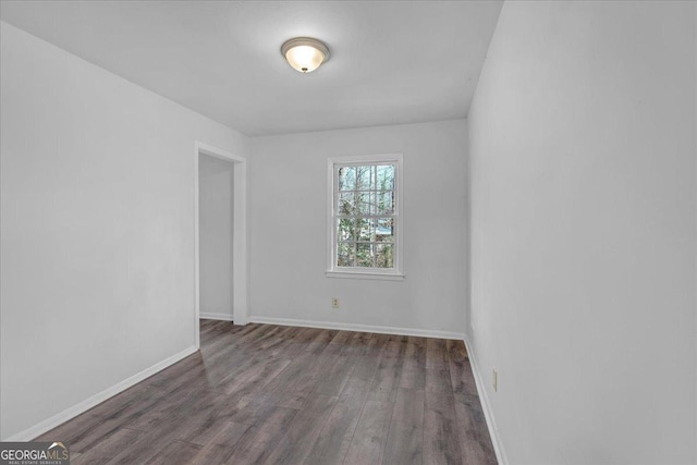 unfurnished room featuring dark hardwood / wood-style floors