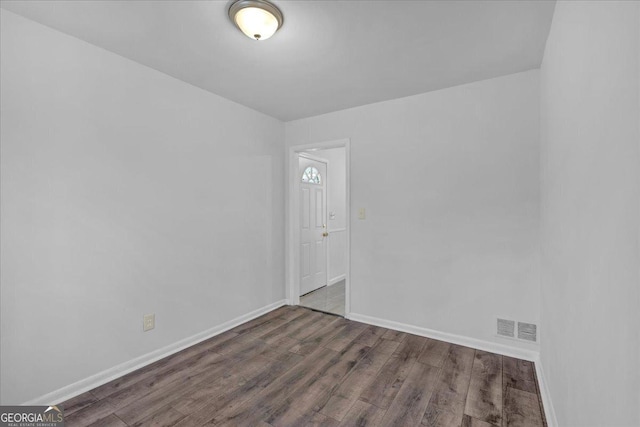 empty room with dark hardwood / wood-style floors